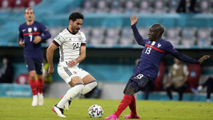 <p>Germany's Ilkay Gundogan, left, battles for the ball with France's N'Golo Kante. Picture: AP Photo/Matthias Schrader</p>