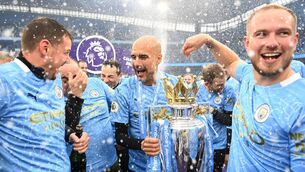 <p>Pep Guardiola celebrates with the Premier League trophy as Manchester City are presented with the title. Picture: Michael Regan/Getty Images</p>
