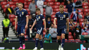 <p>Scotland's Scott McTominay, Jack Hendry and Stuart Armstrong stand dejected during the UEFA Euro 2020 Group D match at Hampden Park</p>