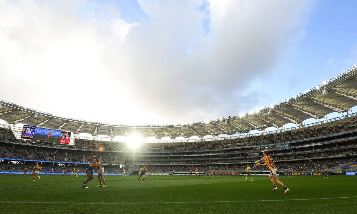 Conor Glass kicks upfield for the Hawks last August at Optus Stadium in Perth, Australia. Uncertainty over a new contract brought him home. He’s now settled into a winning Derry team. Picture: Daniel Carson/AFL Photos via Getty
                    