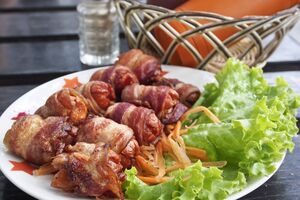 Sausages wrapped in smoky bacon