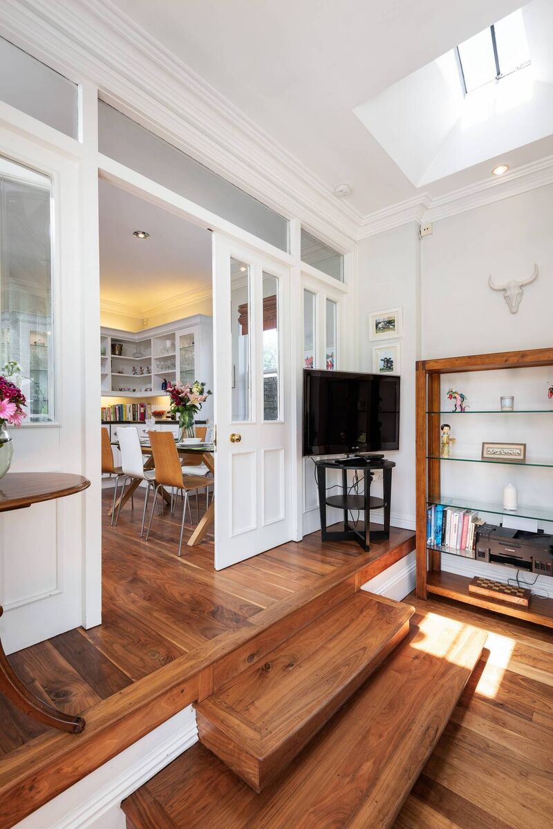 Split level between kitchen/diner and rear family room, with shiny walnut floor Split level between kitchen/diner and rear family room, with shiny walnut floor