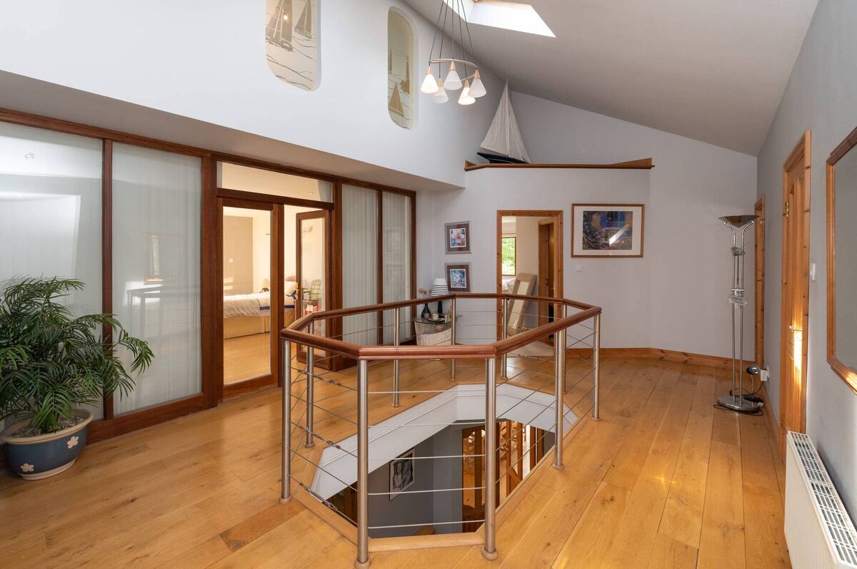 Mid-level with lightwell on first floor landing throwing light to the hall below