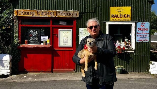 <p>Cónal Creedon and Dogeen outside Johnny Timmy Johnny's in Inchigeelagh. </p>