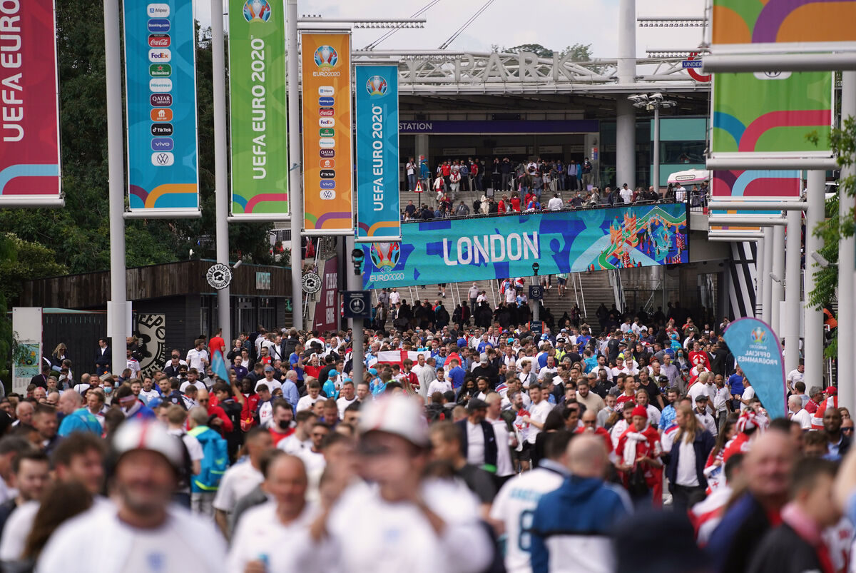 Fans outside Wembley Stadium ahead of the Euro 2020 semi-final match between England and Denmark tonight