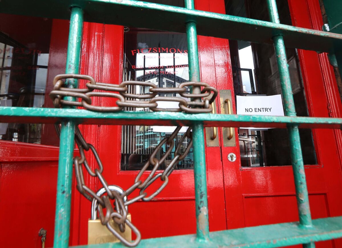 Locked gates at the Fitzsimons pub in Temple Bar, Dublin. The Tánaiste has said the reopening of indoor hospitality will happen 'in advance' of the August bank holiday weekend. Picture: Leah Farrell/RollingNews.ie