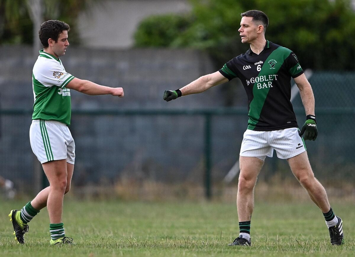 Stephen Cluxton of Parnells bumps fists with Ciarán Gethings of O'Tooles after the game.