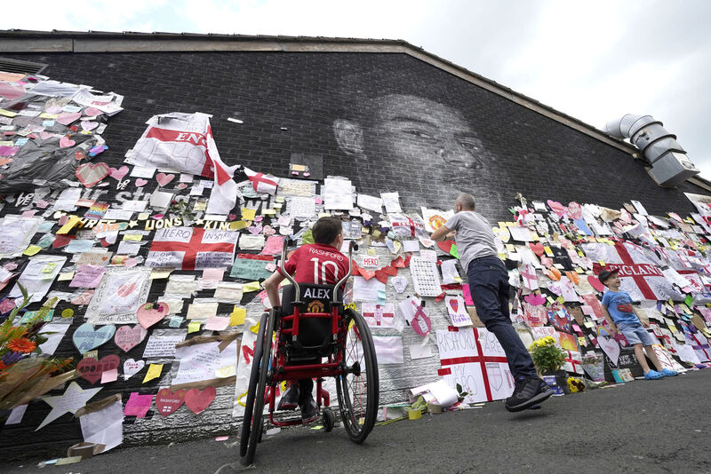 Jon Nield and his son Alex, 14, in front of the mural of Manchester United striker and England player Marcus Rashford on the wall of the Coffee House Cafe on Copson Street, Withington. Picture: Danny Lawson/PA Wire Jon Nield and his son Alex, 14, in front of the mural of Manchester United striker and England player Marcus Rashford on the wall of the Coffee House Cafe on Copson Street, Withington. Picture: Danny Lawson/PA Wire