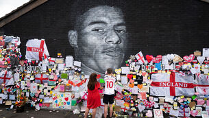 <p>Mackenzie Robertson and his mother Sally Coles-Robertson put up a message on the mural of Manchester United striker and England player Marcus Rashford on the wall of the Coffee House Cafe on Copson Street, Withington. The mural appeared vandalised on Monday after the England football team lost the UEFA Euro 2021 final. </p>