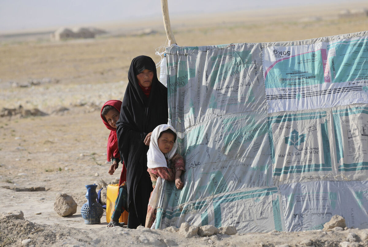 An Afghan woman stands with her daughters in front a makeshift tent in a camp after fleeing fighting between the Taliban and Afghan security personnel, on the edge of the city of Mazar-e-Sharif, northern Afghanistan, last week. Thousands of people have fled Taliban insurgents sweeping across northern Afghanistan, fearful of their harsh rule. Photo: AP/Rahmat Gul An Afghan woman stands with her daughters in front a makeshift tent in a camp after fleeing fighting between the Taliban and Afghan security personnel, on the edge of the city of Mazar-e-Sharif, northern Afghanistan, last week. Thousands of people have fled Taliban insurgents sweeping across northern Afghanistan, fearful of their harsh rule. Photo: AP/Rahmat Gul