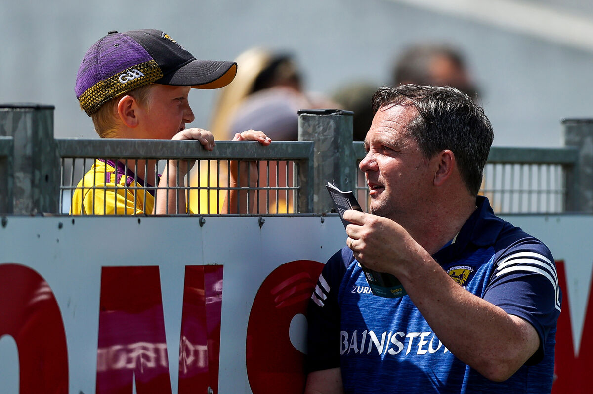 Davy Fitzgerald signs a young Wexford fan's matchday programme at Semple Stadium. Picture: INPHO/Tommy Dickson