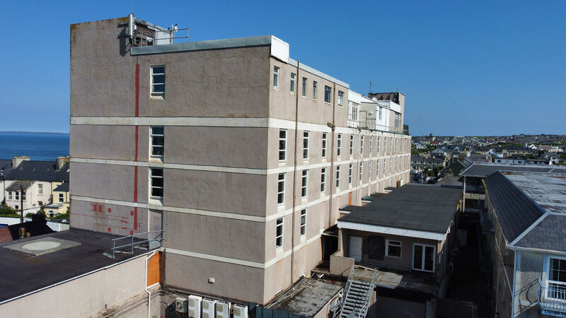 Looming high over the mix of Victorian and Edwardian-era town houses below it on the north Kerry beach resort’s Main Street, the Golf Hotel has all the charm of an inner-city office block. Picture: Neil Michael Looming high over the mix of Victorian and Edwardian-era town houses below it on the north Kerry beach resort’s Main Street, the Golf Hotel has all the charm of an inner-city office block. Picture: Neil Michael