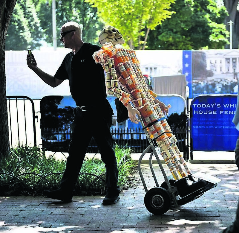 Frank Huntley, who struggled with addiction, walks with Pill Man, a skeleton made from his oxycontin and methadone prescription bottles, along Pennsylvania Avenue August 30, 2019, in Washington, DC. Picture: Brendan Smialowski/AFP Frank Huntley, who struggled with addiction, walks with Pill Man, a skeleton made from his oxycontin and methadone prescription bottles, along Pennsylvania Avenue August 30, 2019, in Washington, DC. Picture: Brendan Smialowski/AFP