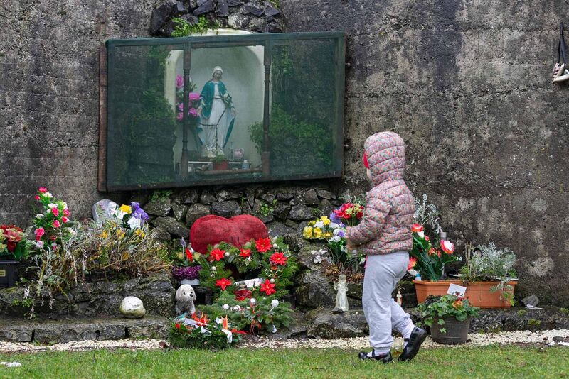 A child leaving flowers at Tuam Mother and Baby site. Picture: Andy Newman