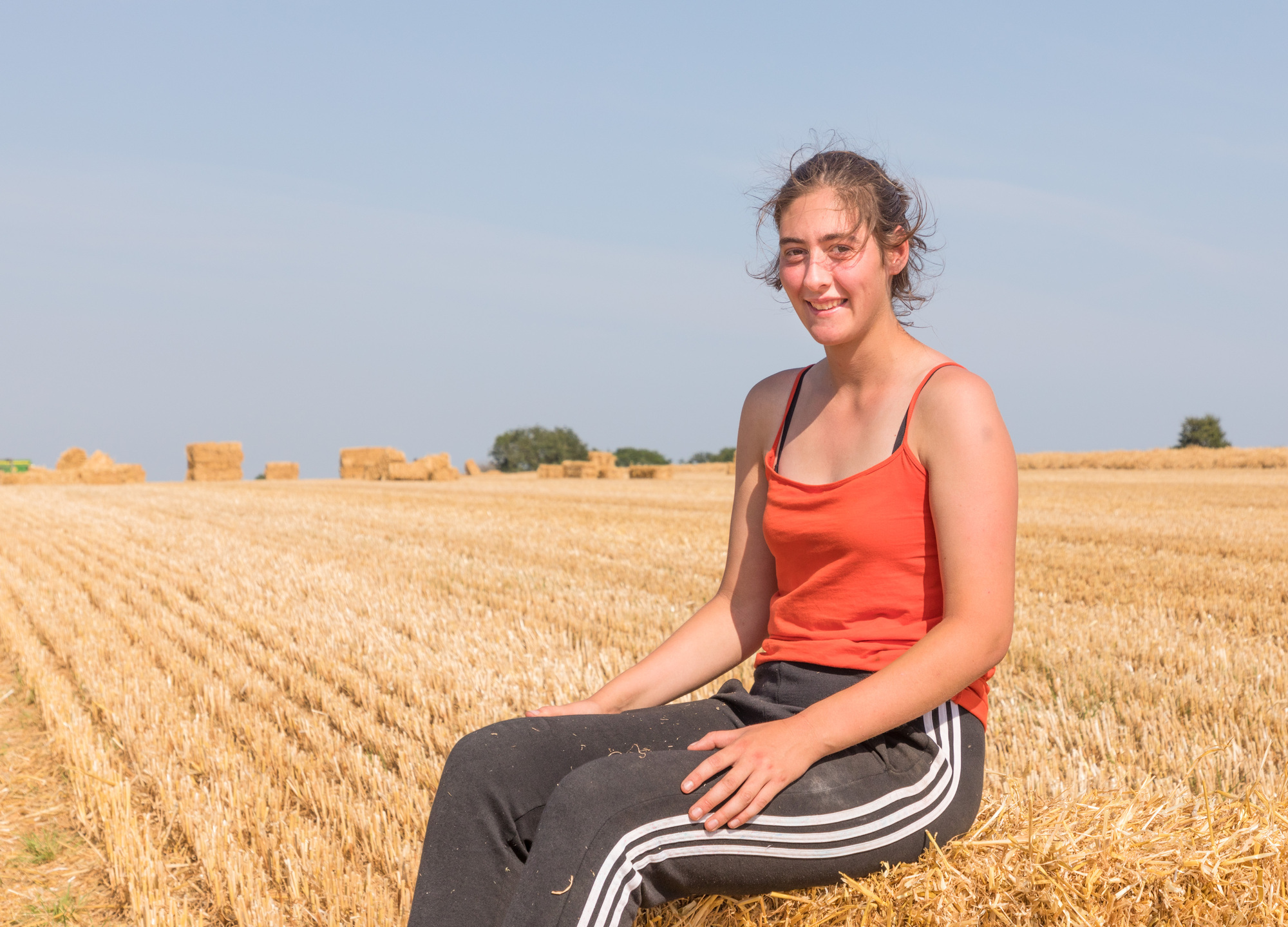 Amanda Draper takes a rest from working on the family farm as they bale over three thousand square bales in Riverstick, Co Cork.  Picture: David Creedon. 