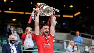 <p>Tyrone's Padraig Hampsey lifts the cup. Picture: INPHO/Tommy Grealy</p>