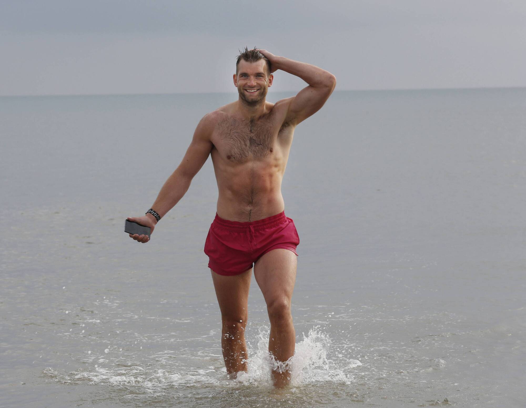 Mayo Captain Aidan O’Shea, pictured walking out of the sea during a photocall to announce that tech-repairs group PAIR Mobile are celebrating their 10th birthday. 