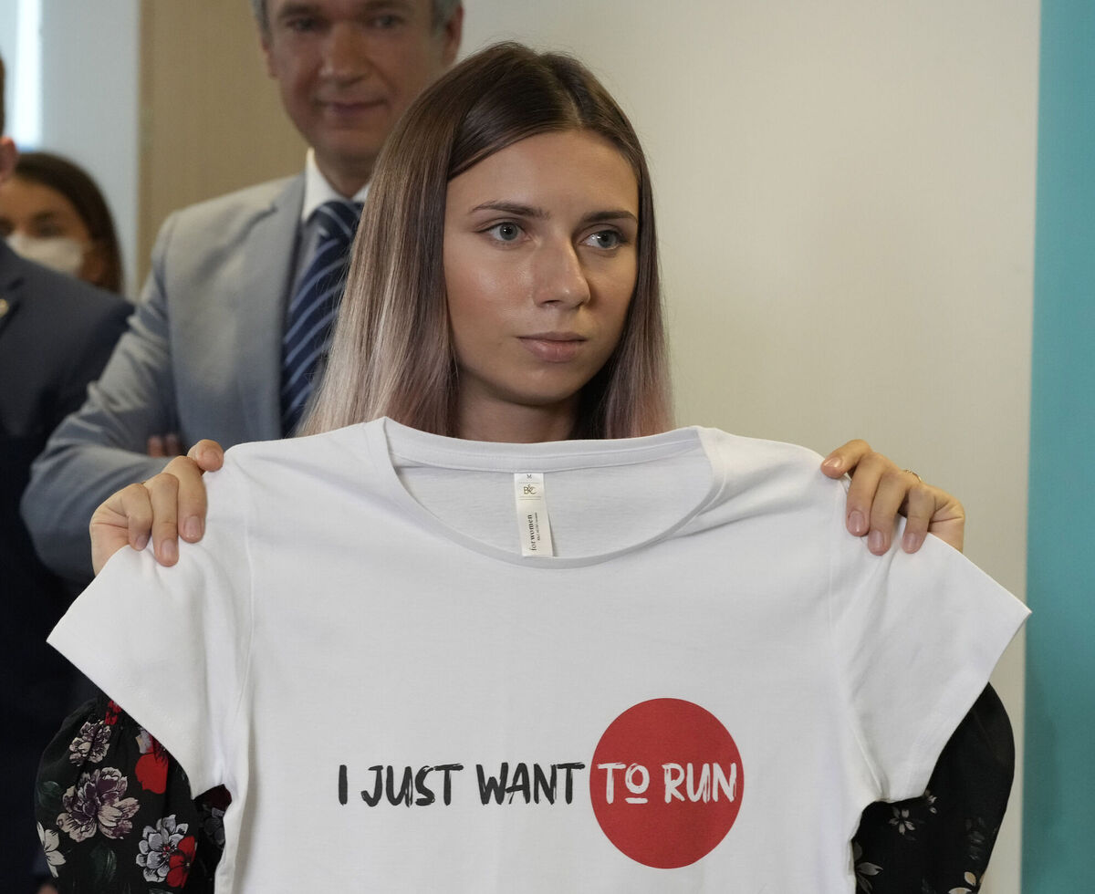 Belarusian Olympic sprinter Krystsina Tsimanouskaya shows Olympic-related T-shirt with her slogan "I Just Want to Run" after her news conference in Warsaw, Poland, on Thursday Belarusian Olympic sprinter Krystsina Tsimanouskaya shows Olympic-related T-shirt with her slogan "I Just Want to Run" after her news conference in Warsaw, Poland, on Thursday