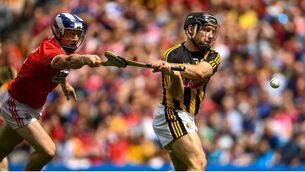 <p>Richie Hogan of Kilkenny shoots to score his side's second goal of the game despite the attention of Sean O'Donoghue of Cork. Picture: Ramsey Cardy/Sportsfile</p>