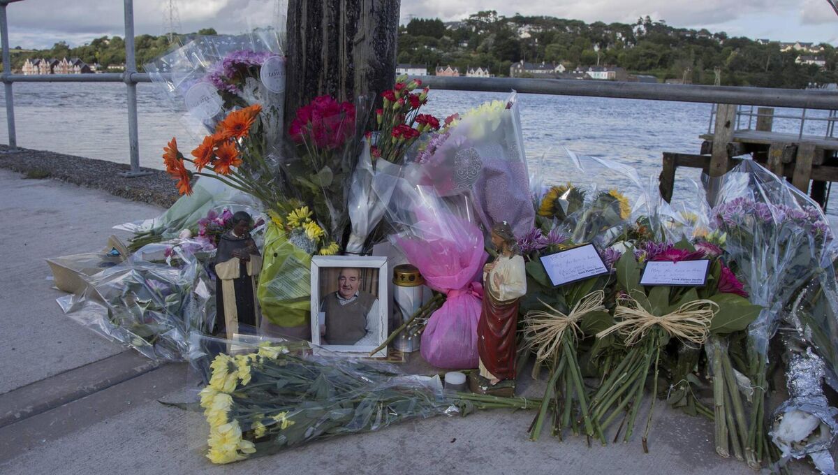 Flowers are laid at the scene of the fatal crash in Monkstown, Co Cork, where bus driver Mark Wills and Catholic priest Fr Con Cronin lost their lives on Tuesday. 