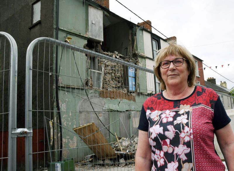 Cllr Kay Dawson against the backdrop of a derelict building.