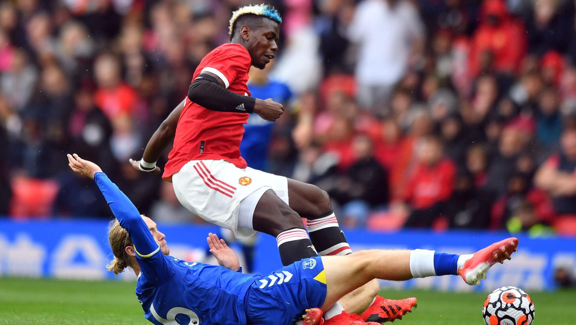 Manchester United's Paul Pogba and Everton's Tom Davies battle for the ball during the pre-season friendly match at Old Trafford.