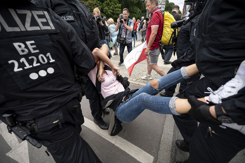 Police arrest a demonstrator at an unauthorised Querdenker demonstration in Berlin last Sunday.  Michael Ballweg denies Querdenker’s proximity to – let alone association with – extremists, claiming that such perceptions are the result of misleading and biased media reporting. Photo: Fabian Sommer/dpa via AP