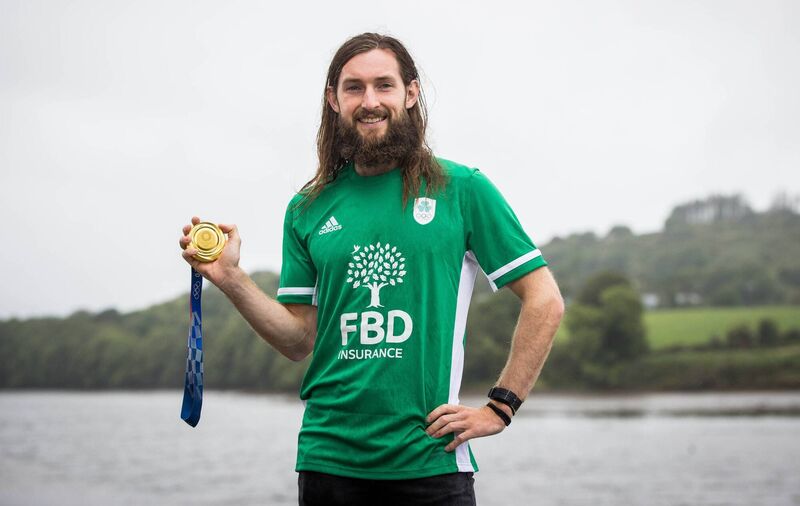Paul O’Donovan, Olympic rower, holding his gold medal by the river Ilen Pic©INPHO/Ryan Byrne