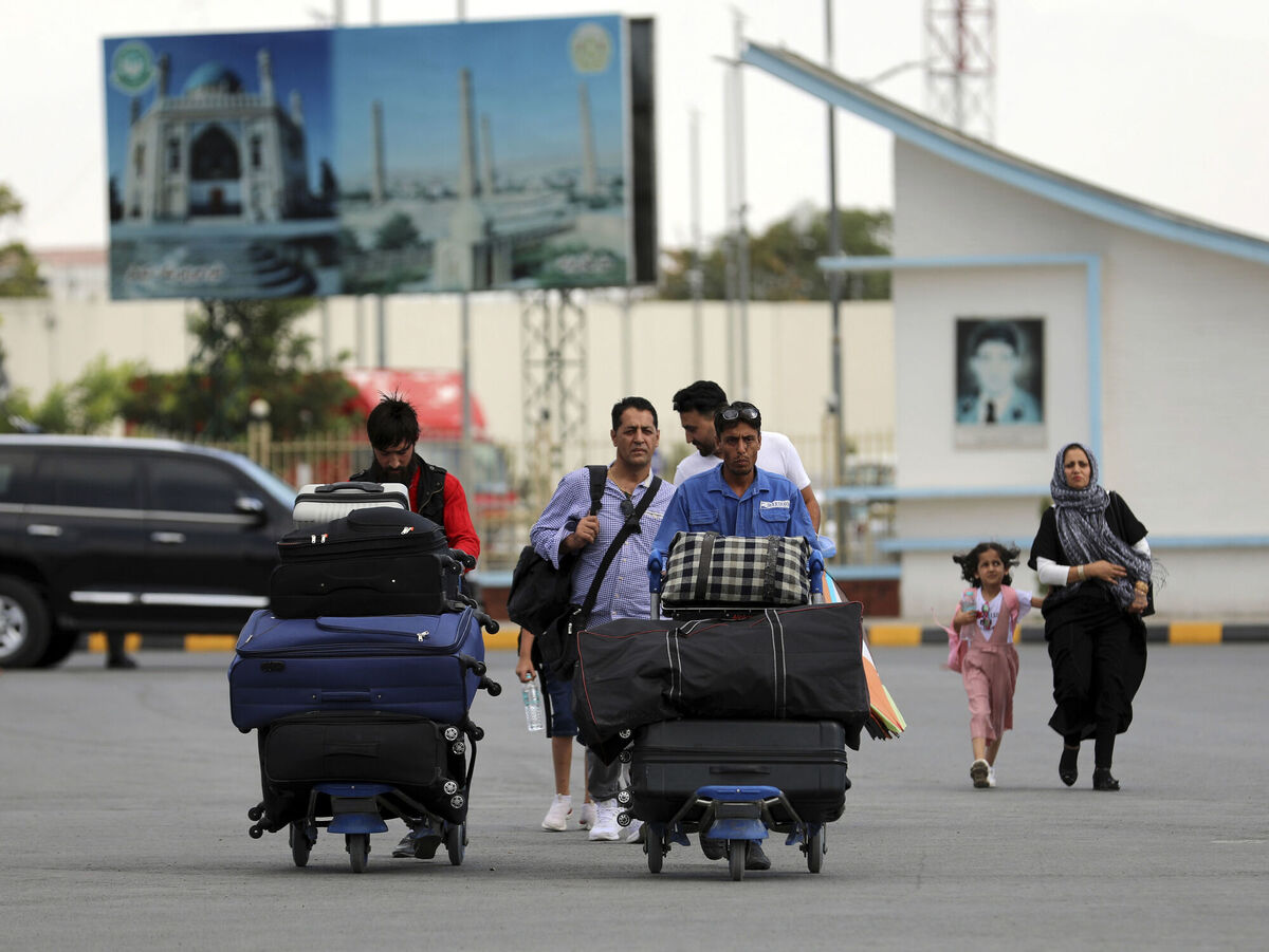 Passengers walk to the departures terminal of Hamid Karzai International Airport in Kabul, Afghanistan. Picture: AP Photo/Rahmat Gul Passengers walk to the departures terminal of Hamid Karzai International Airport in Kabul, Afghanistan. Picture: AP Photo/Rahmat Gul