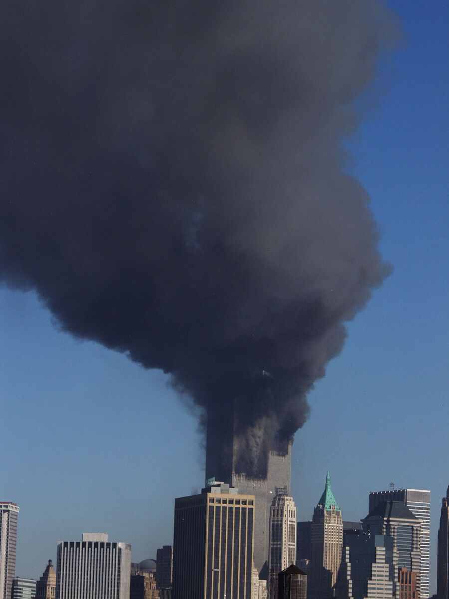 Plumes of smoke pour from the World Trade Center buildings in New York on September 11, 2001.
