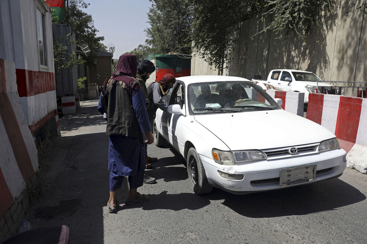 Taliban fighters search a vehicle at a checkpoint on the road to the Afghan foreign ministry in Kabul. Picture: AP Photo/Rahmat Gul