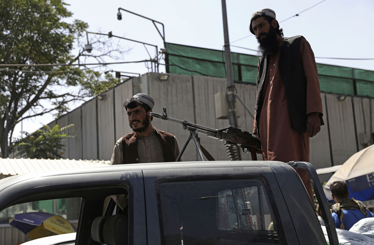 Taliban fighters stand guard on the back of vehicle with a machine gun in front of main gate leading to Afghan presidential palace, in Kabul, Afghanistan. Picture: AP Photo/Rahmat Gul Taliban fighters stand guard on the back of vehicle with a machine gun in front of main gate leading to Afghan presidential palace, in Kabul, Afghanistan. Picture: AP Photo/Rahmat Gul