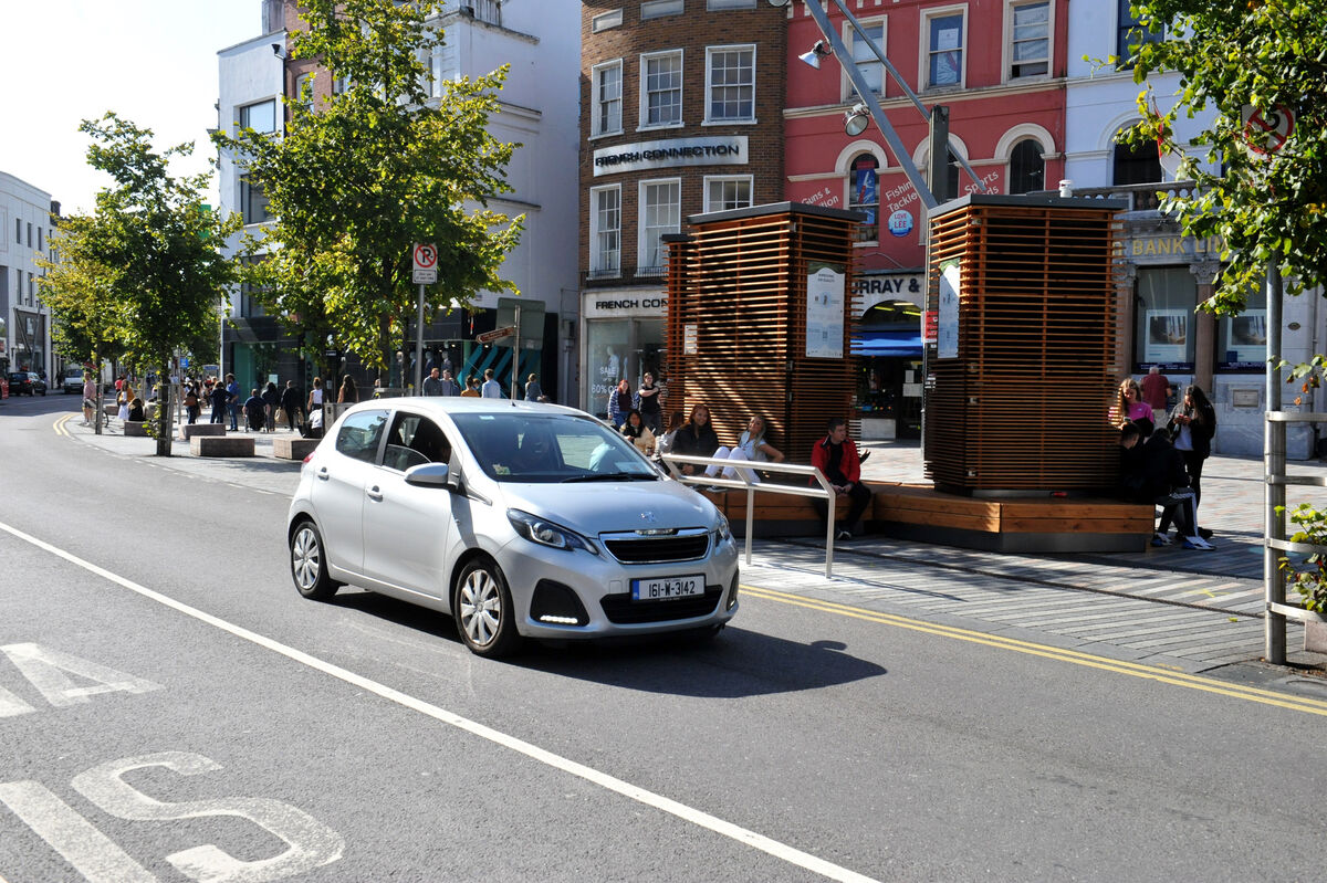 The devices, which double as street furniture, are covered in a mixture of moss cultures that filter harmful pollutants out of the air. Photo: Larry Cummins