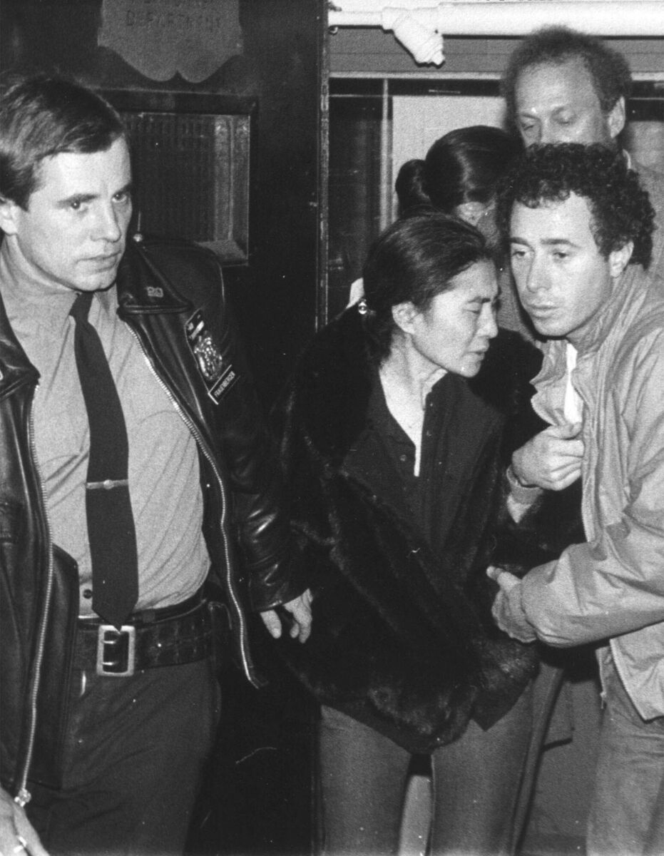 Yoko Ono is aided by a policeman and David Geffen, right, of Geffen Records as she leaves Roosevelt Hospital after learning that the her husband, John Lennon, had died. Picture: AP
Yoko Ono is aided by a policeman and David Geffen, right, of Geffen Records as she leaves Roosevelt Hospital after learning that the her husband, John Lennon, had died. Picture: AP
