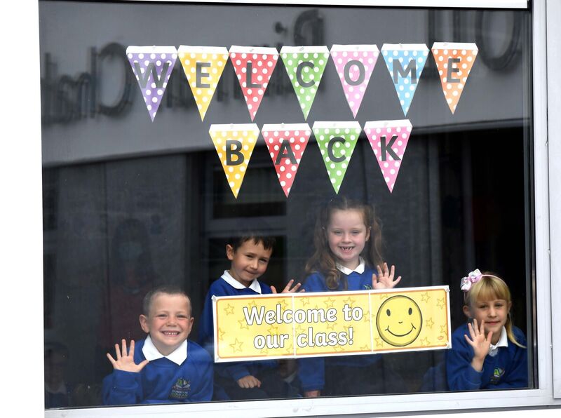 Senior infants (from left) Seamus Hoey, Scott Geasley, Liv Edmonds and Ala Byrne waving as they are welcomed back to school at Bunscoil Rinn an Chabhlaigh, Cobh. Picture: Denis Minihane. Senior infants (from left) Seamus Hoey, Scott Geasley, Liv Edmonds and Ala Byrne waving as they are welcomed back to school at Bunscoil Rinn an Chabhlaigh, Cobh. Picture: Denis Minihane.