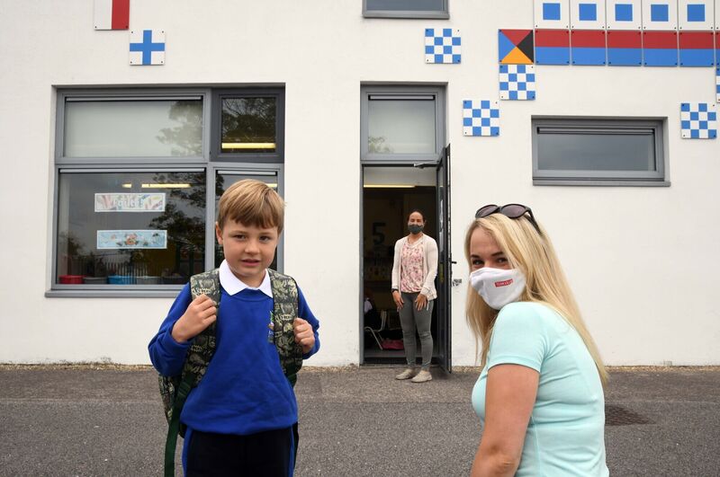 Seán Doherty arriving for his first day in school with his mother Jackie as teacher Siobhán Looney waited at the classroom door at Bunscoil Rinn an Chabhlaigh, Rushbrooke, Cobh, Co Cork. Picture: Denis Minihane. Seán Doherty arriving for his first day in school with his mother Jackie as teacher Siobhán Looney waited at the classroom door at Bunscoil Rinn an Chabhlaigh, Rushbrooke, Cobh, Co Cork. Picture: Denis Minihane.