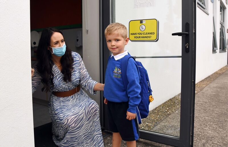 Sam Hayes arriving on the first day in school being greeted by Orla O'Neill, teacher, at Bunscoil Rinn an Chabhlaigh. Picture: Denis Minihane. Sam Hayes arriving on the first day in school being greeted by Orla O'Neill, teacher, at Bunscoil Rinn an Chabhlaigh. Picture: Denis Minihane.