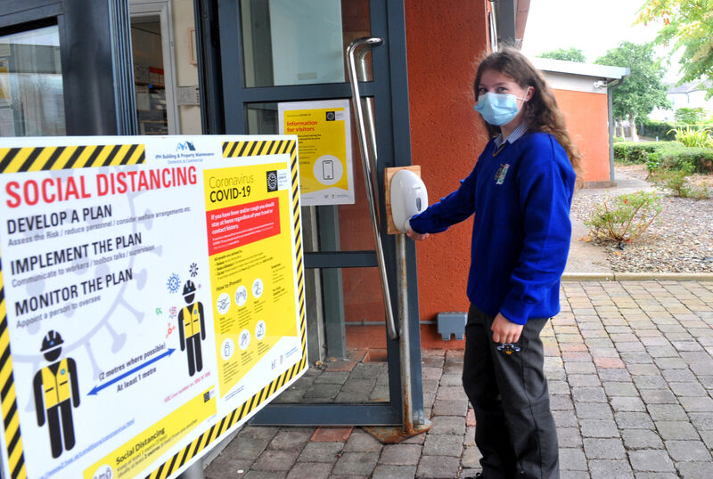 Isabel Twomey sanitises her hands upon entry to the school on her first day at secondary school. Picture: Larry Cummins. Isabel Twomey sanitises her hands upon entry to the school on her first day at secondary school. Picture: Larry Cummins.