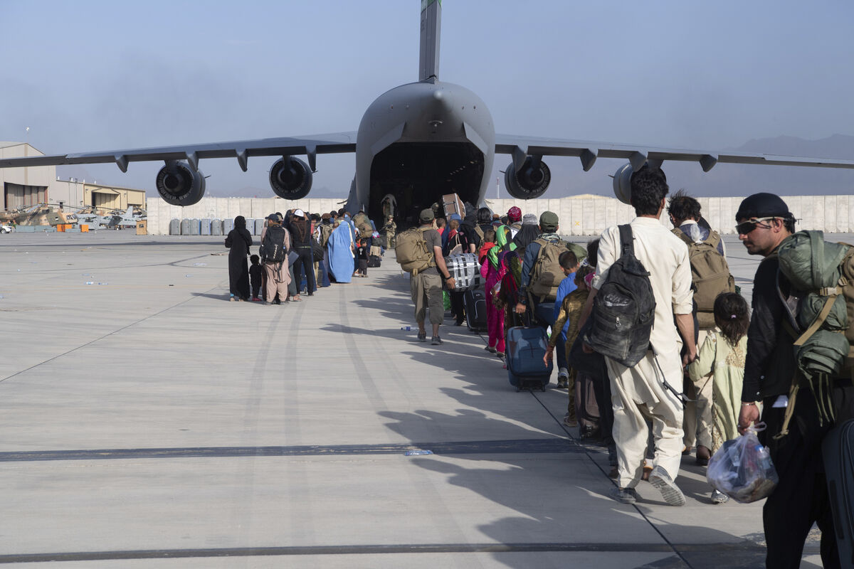 Air Force loadmasters and pilots load people being evacuated from Afghanistan onto a US Air Force C-17 Globemaster III at Hamid Karzai International Airport in Kabul on Tuesday. Picture: AP