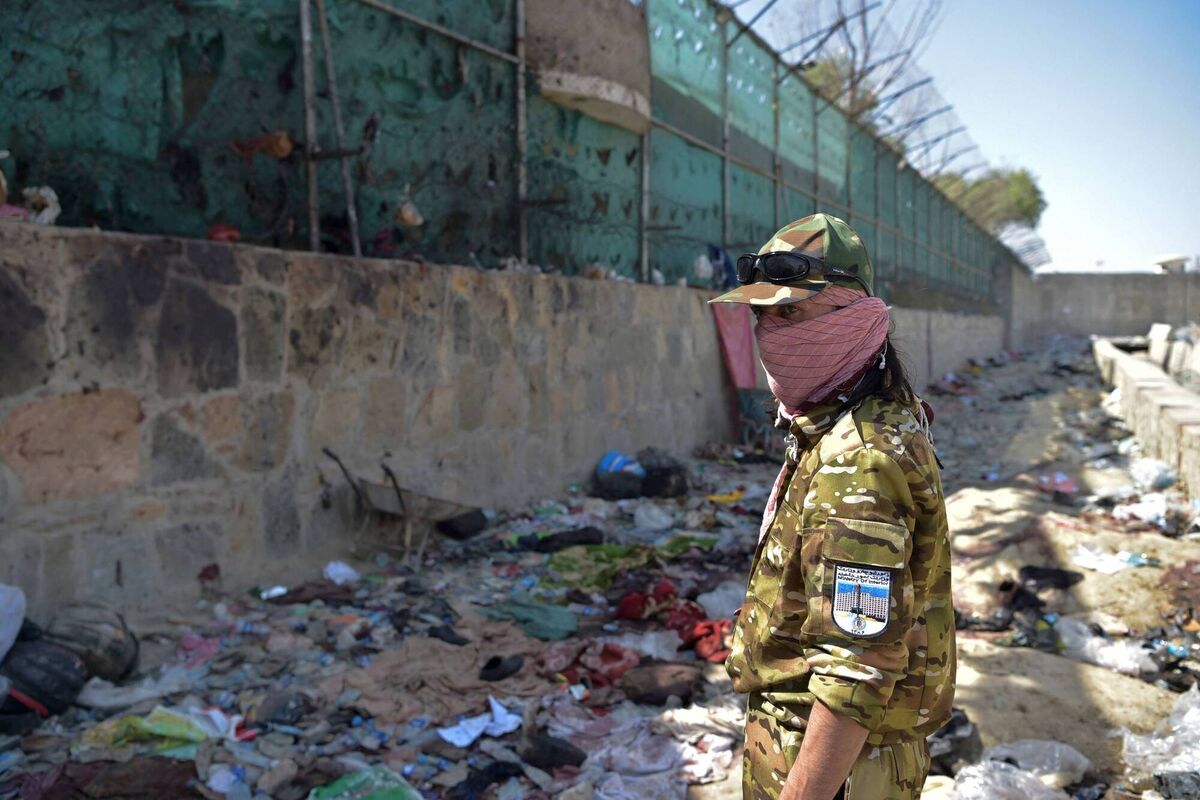 A Taliban fighter stands guard at the site of the August 26 suicide attack which killed 13 US troops A Taliban fighter stands guard at the site of the August 26 suicide attack which killed 13 US troops