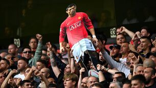 <p>Fans of Manchester United hold up a cardboard cutout of New Signing Cristiano Ronaldo during the Premier League match against Wolverhampton Wanderers. Picture: Shaun Botterill/Getty Images</p>