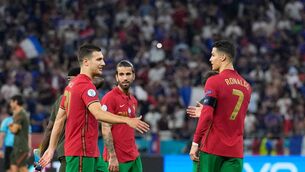 <p>Portugal's defender Joao Cancelo (L) shakes hands with Portugal's forward Cristiano Ronaldo at the end of the UEFA EURO 2020 Group F clash with France in June. Picture: Getty Images</p>