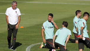 <p>MAN OF THE MOMENT: Cristiano Ronaldo, centre, chats with Portugal coach Fernando Santos, left, during yesterday’s training session in Oeiras. A Ronaldo goal against Ireland would see him become the top scorer in the history of international football. 	<span class="contextmenu emphasis CaptionCredit">Picture: AP Photo/Armando Franca</span>
            </p>