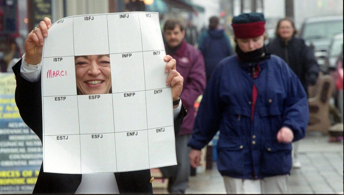 Marci Segal holds up the Myers Briggs Type Chart. The chart sets out 16 personality types that most people fall into. Her name is printed in the square her type is. (Photo by Ken Faught/Toronto Star via Getty Images)