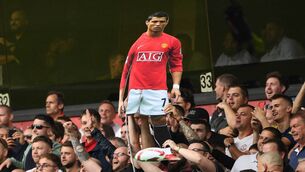 <p>A cardboard cutout of new signing Cristiano Ronaldo is held by Manchester United supporters during the Premier League match against Wolves. Picture: Oli Scarff</p>