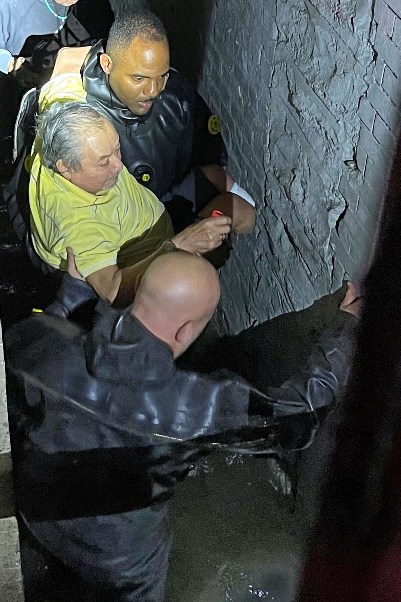 Special Operations personnel rescuing a man from his flooded basement apartment, in New York. Picture: New York City Police Department/via AP