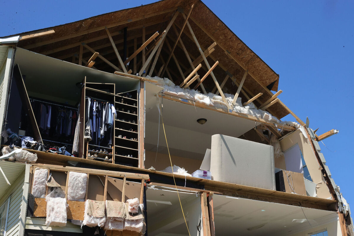 Homeowners clean up damage the day after a tornado touched down in Harrison Township, New Jersey. Picture: Edward Lea /The Press of Atlantic City/ via AP
