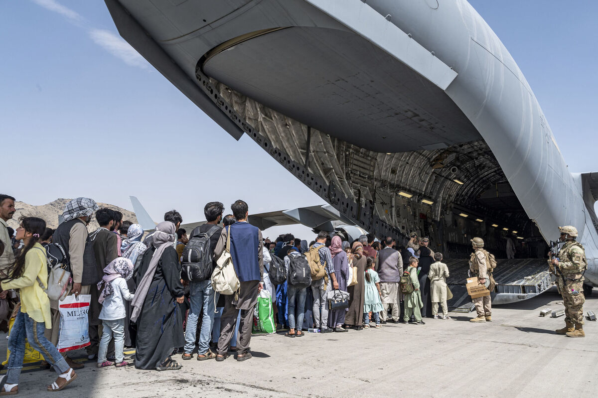 US Airmen and Marines guide evacuees aboard a US Air Force C-17 Globemaster III in support of the Afghanistan evacuation at Hamid Karzai International Airport in Kabul, Afghanistan, last month. Picture: AP US Airmen and Marines guide evacuees aboard a US Air Force C-17 Globemaster III in support of the Afghanistan evacuation at Hamid Karzai International Airport in Kabul, Afghanistan, last month. Picture: AP