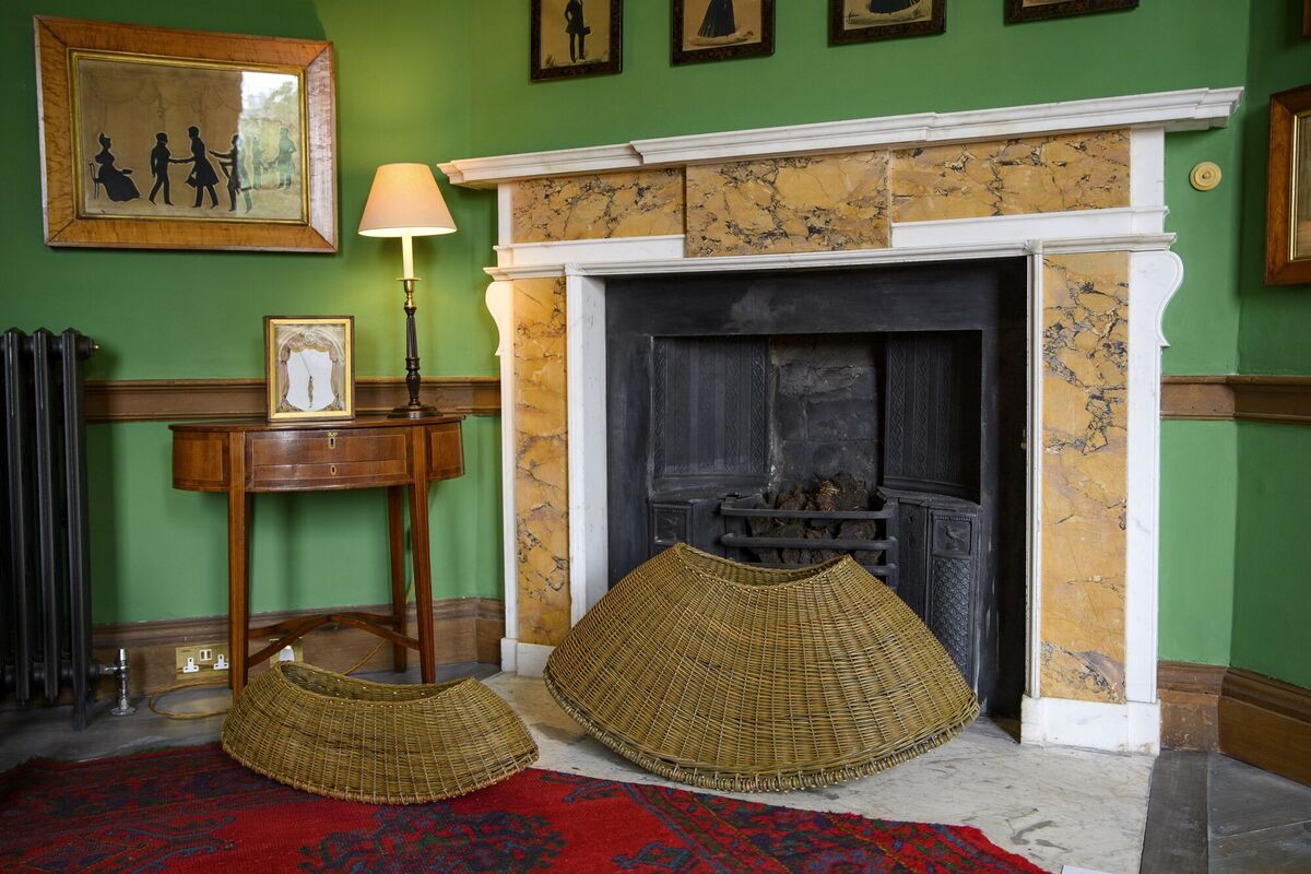 Basket work by Annemarie O'Sullivan sits by a fireplace as similar baskets would have done in the past to hold sticks and turf for the fire. Basket work by Annemarie O'Sullivan sits by a fireplace as similar baskets would have done in the past to hold sticks and turf for the fire.