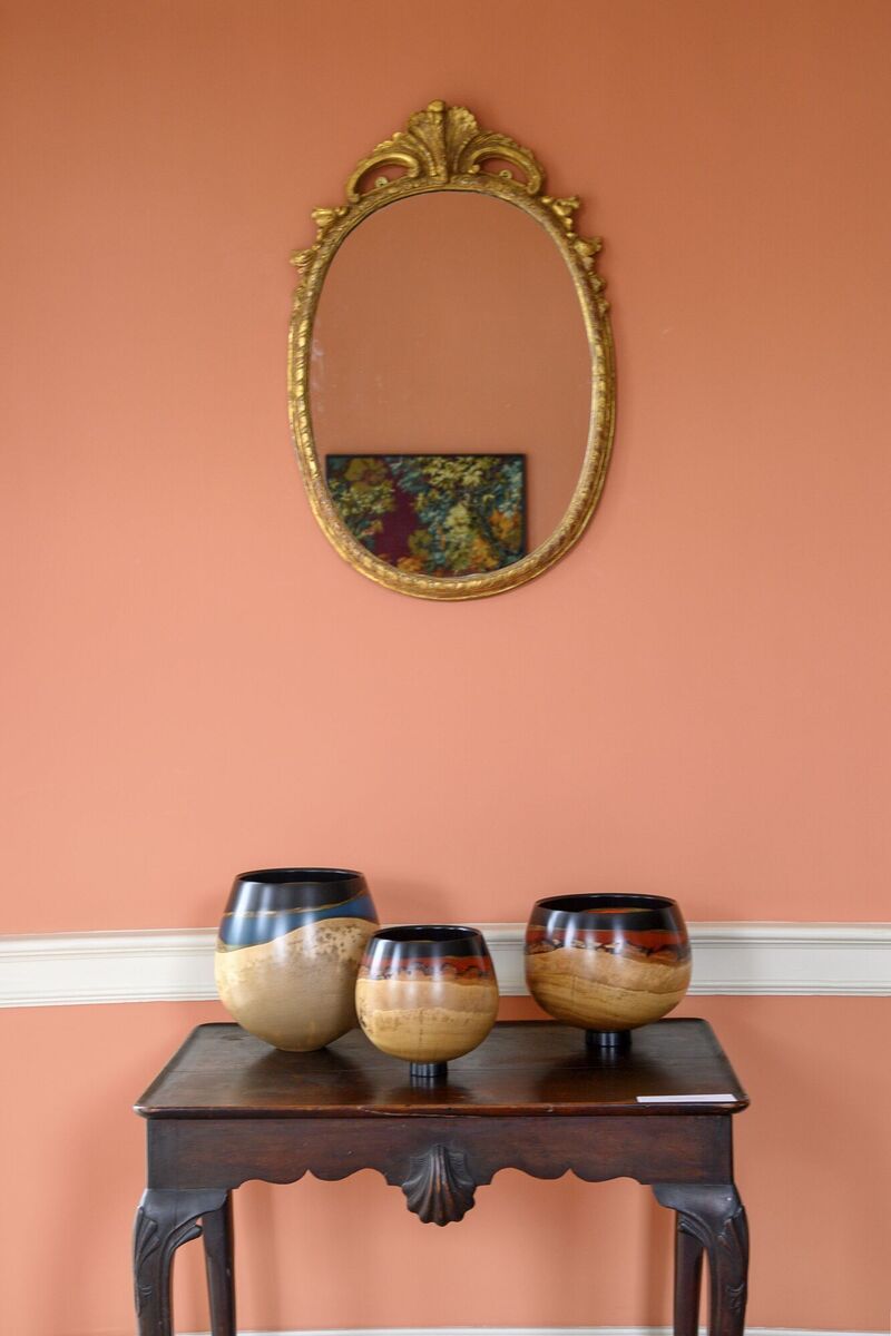 Kathleen Walsh's Blue Dune #1 vessel in sycamore, gold, turquoise and black resin, and Amber Wave #2 and #1 in oak, gold, amber and black resin sit on a console table beneath an antique mirror reflecting Matt Smith's The Lovers, a reworked textile and wool hanging. Kathleen Walsh's Blue Dune #1 vessel in sycamore, gold, turquoise and black resin, and Amber Wave #2 and #1 in oak, gold, amber and black resin sit on a console table beneath an antique mirror reflecting Matt Smith's The Lovers, a reworked textile and wool hanging.